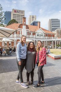Olivia Lee (centre) with students from ACU, Monica Dimon (left) and Anna Vlastelica. Photo: Elizabeth McFarlane