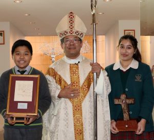 Bishop Vincent Long OFM Conv with students holding the relics of Mother Teresa and St Mary of the Cross MacKillop at the launch of the Way of Mercy on 8 August 2016.