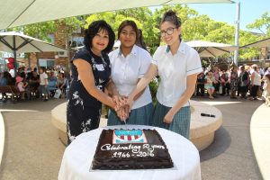 Alumni President, Vicki Baiada, Class of 1968, and two current school captains cut the 50th anniversary cake. Image: source. 