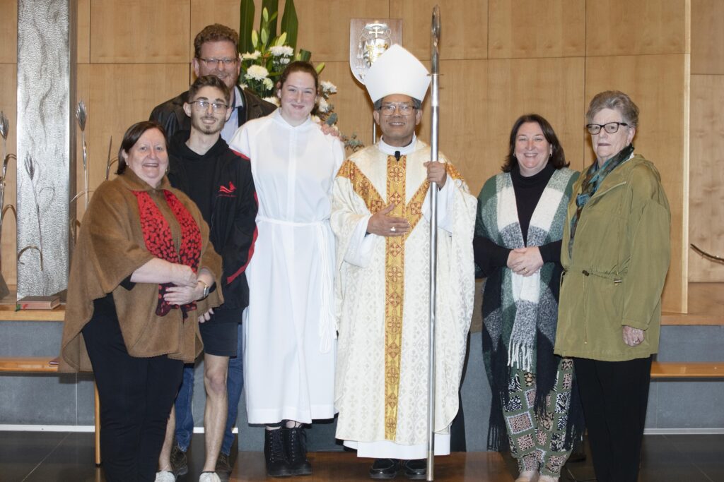 Bishop Vincent with young Minister of the Altar and her family