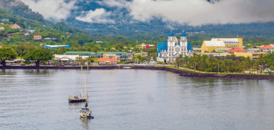 View of the water front of the capital city Apia, Samoa, with the cathedral of the Immaculate Conception prominent in the skyline. Image: Shutterstock.